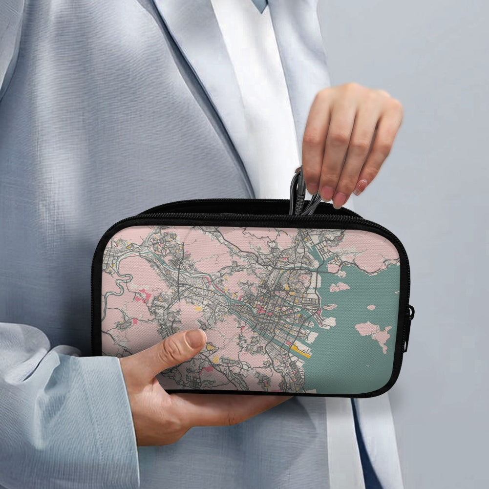 Person holding a small rectangular bag with a map design on a plain background