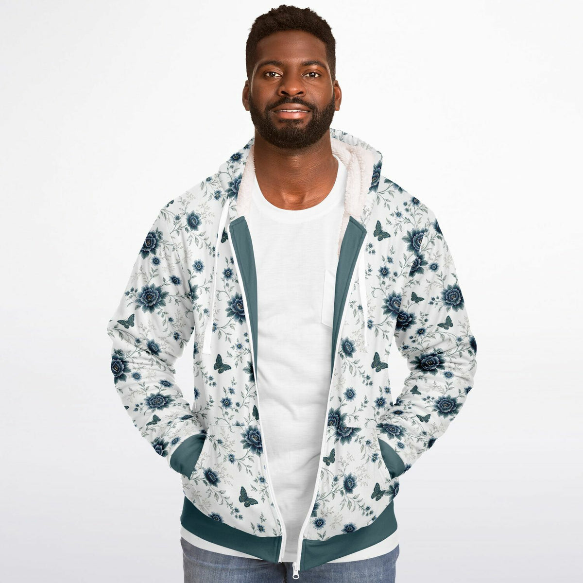 A man wearing a white zip-up hoodie with a blue floral pattern, teal green trim, and a white t-shirt underneath, photographed against a solid white background.