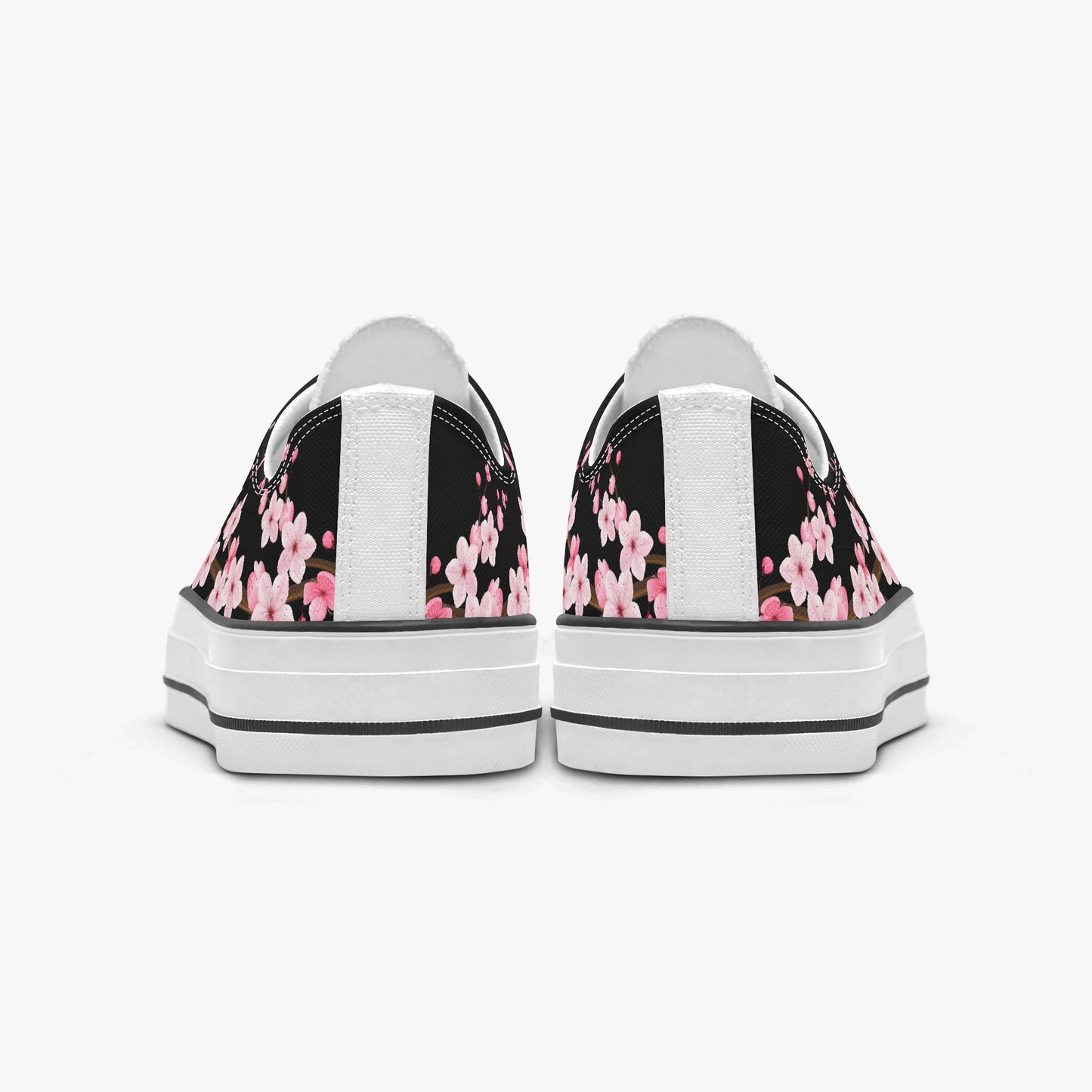 Black sneakers with pink floral pattern on a white background