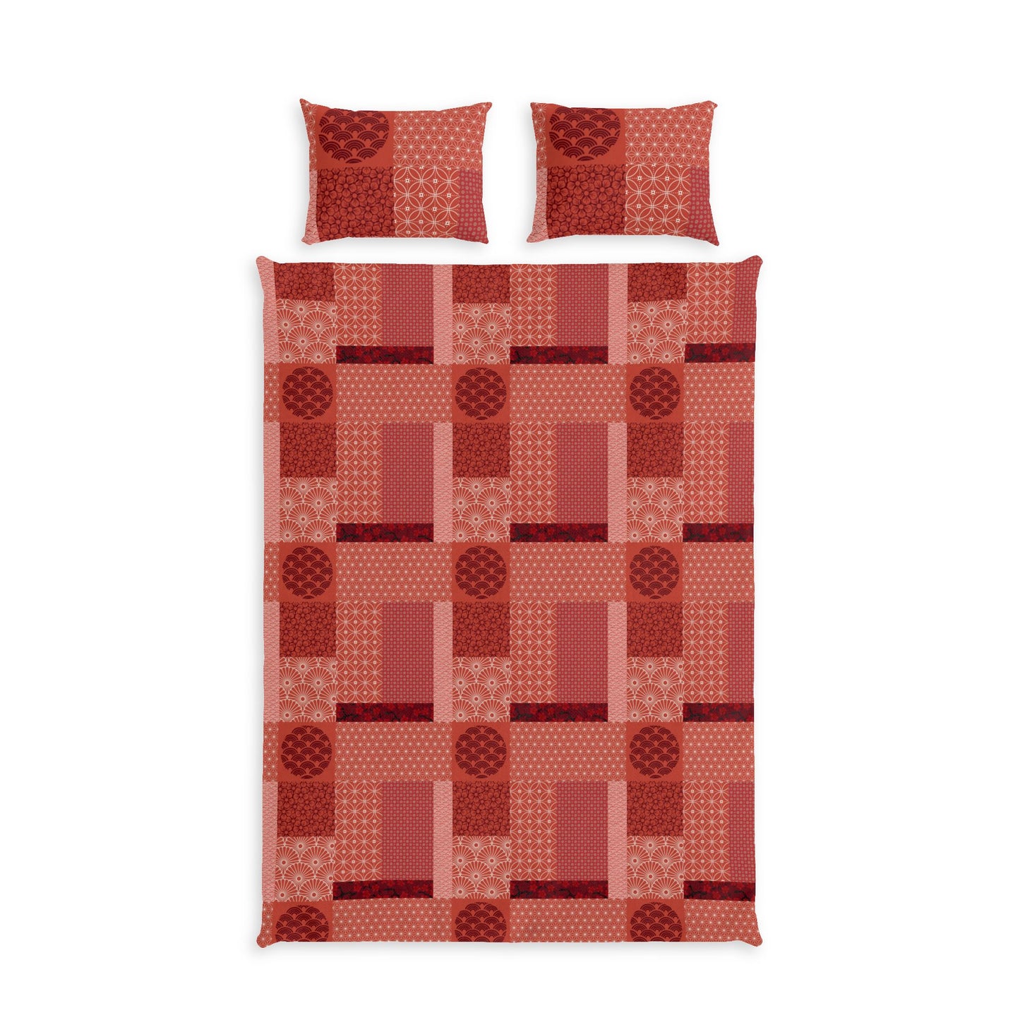 A bedding set featuring a patchwork quilt and two matching pillowcases in a warm red and orange geometric pattern, shown against a plain white background.