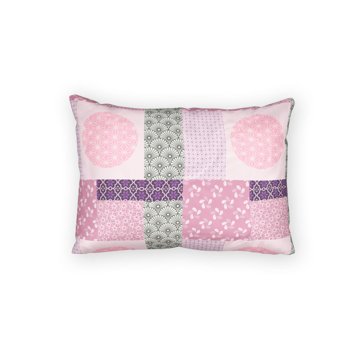 A rectangular throw pillow featuring a patchwork design of various pink, purple, and gray patterned fabric squares, set against a plain white background.