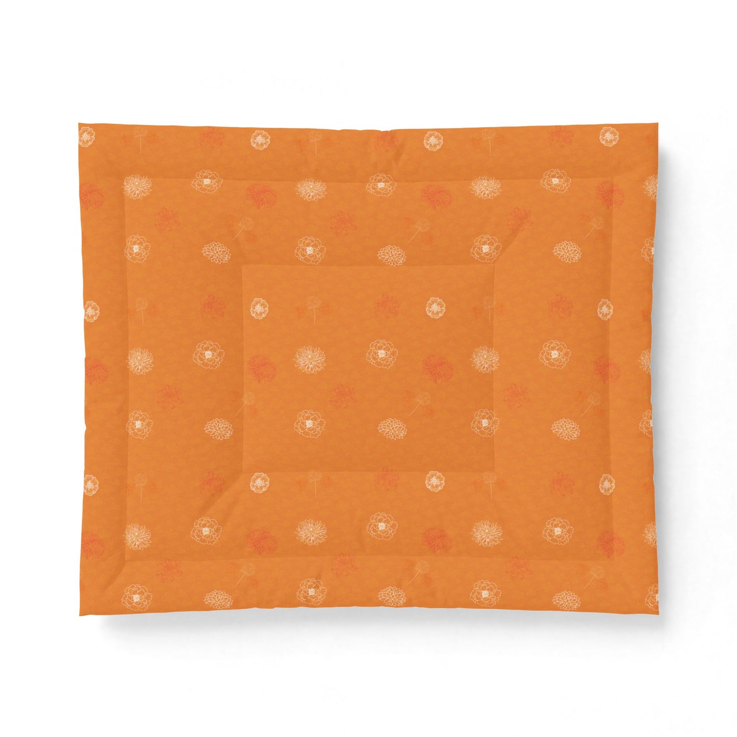 An orange square fabric item, likely a quilt or comforter, featuring a subtle pattern of small white and muted red floral motifs, displayed flat against a white background.
