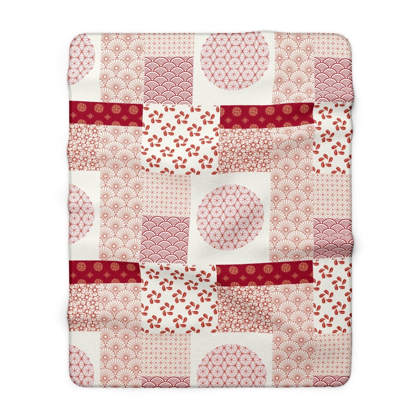 Patchwork quilt with red and pink patterns on a white background