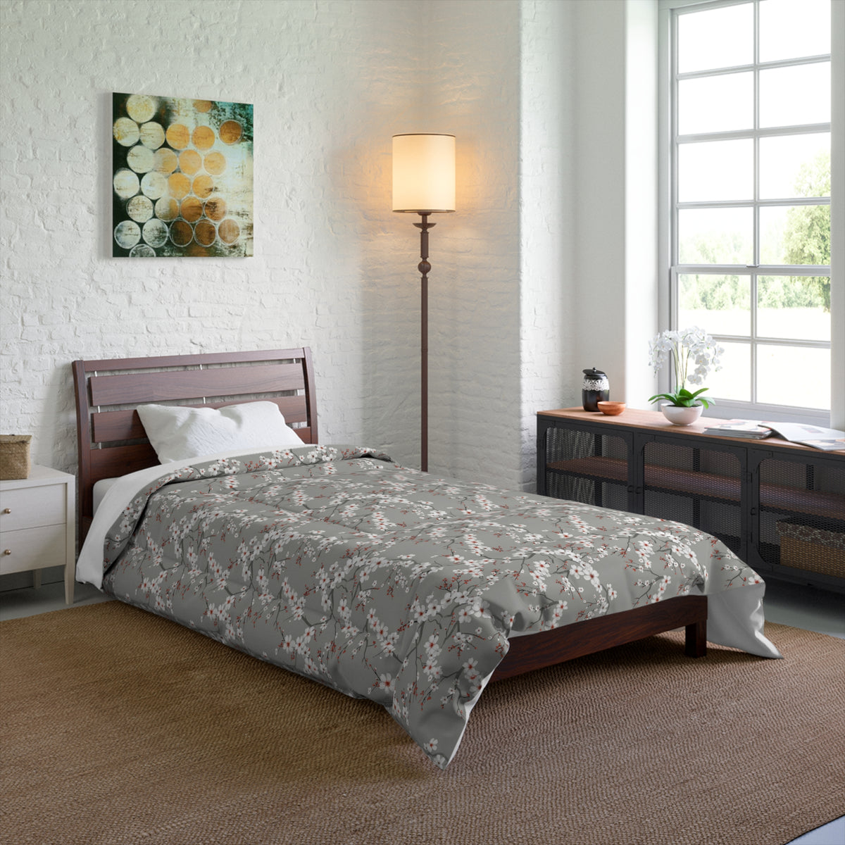 Bedroom with floral comforter on a bed, lamp, and window.