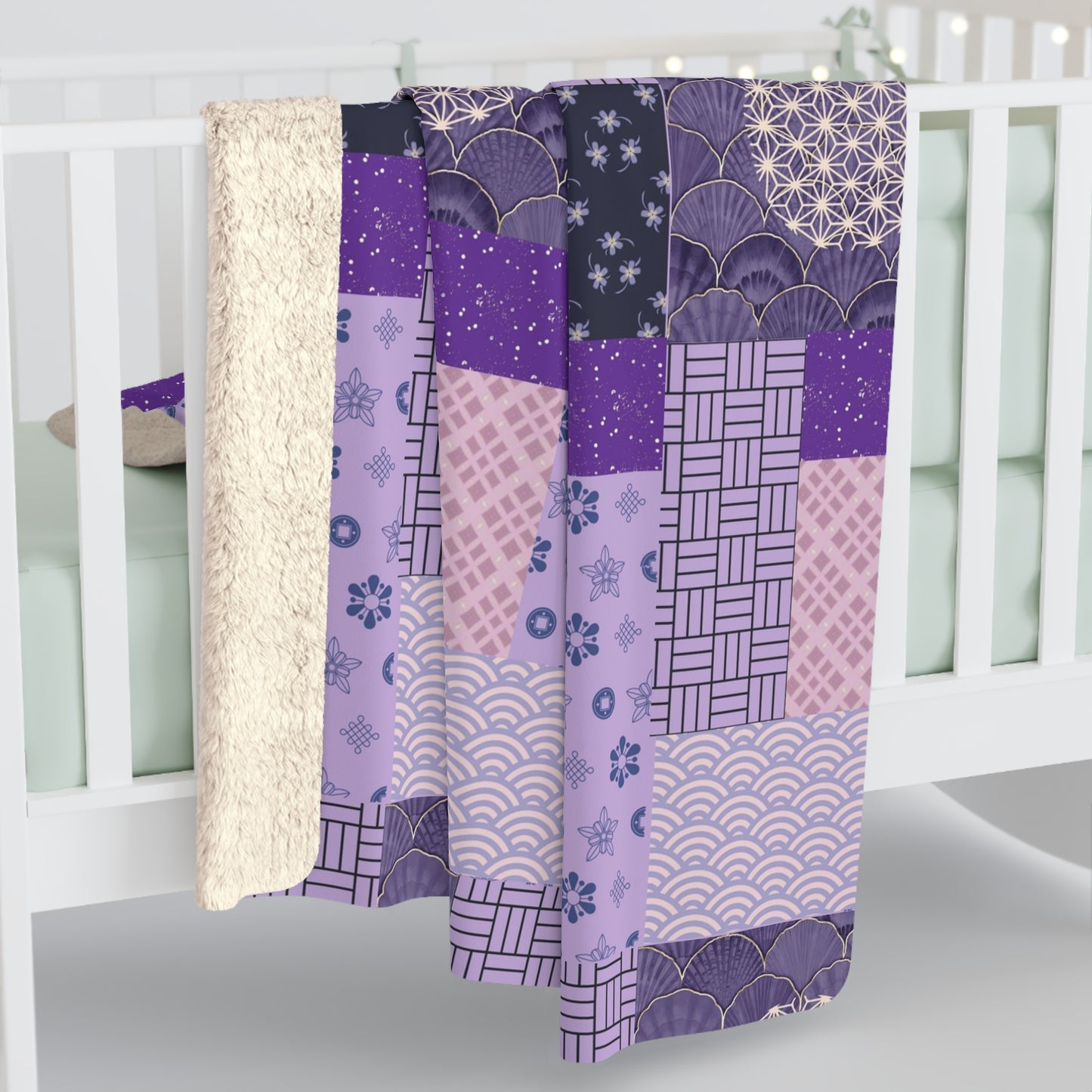 Patchwork quilt with purple and pink patterns draped over a crib.
