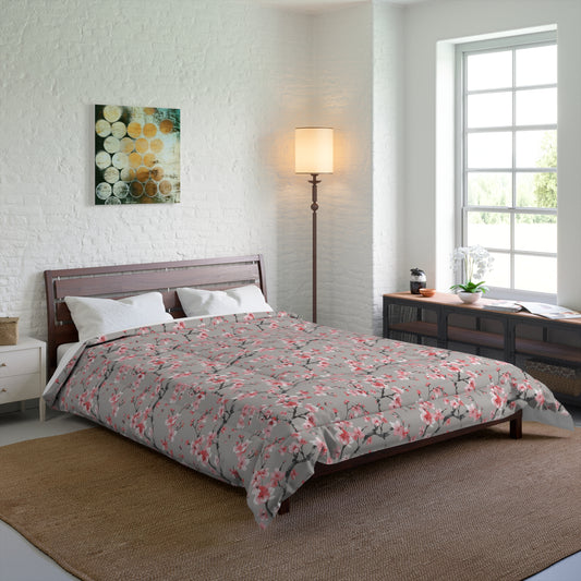Bedroom with a bed featuring a gray comforter with orange floral patterns, a lamp, and a painting on the wall.