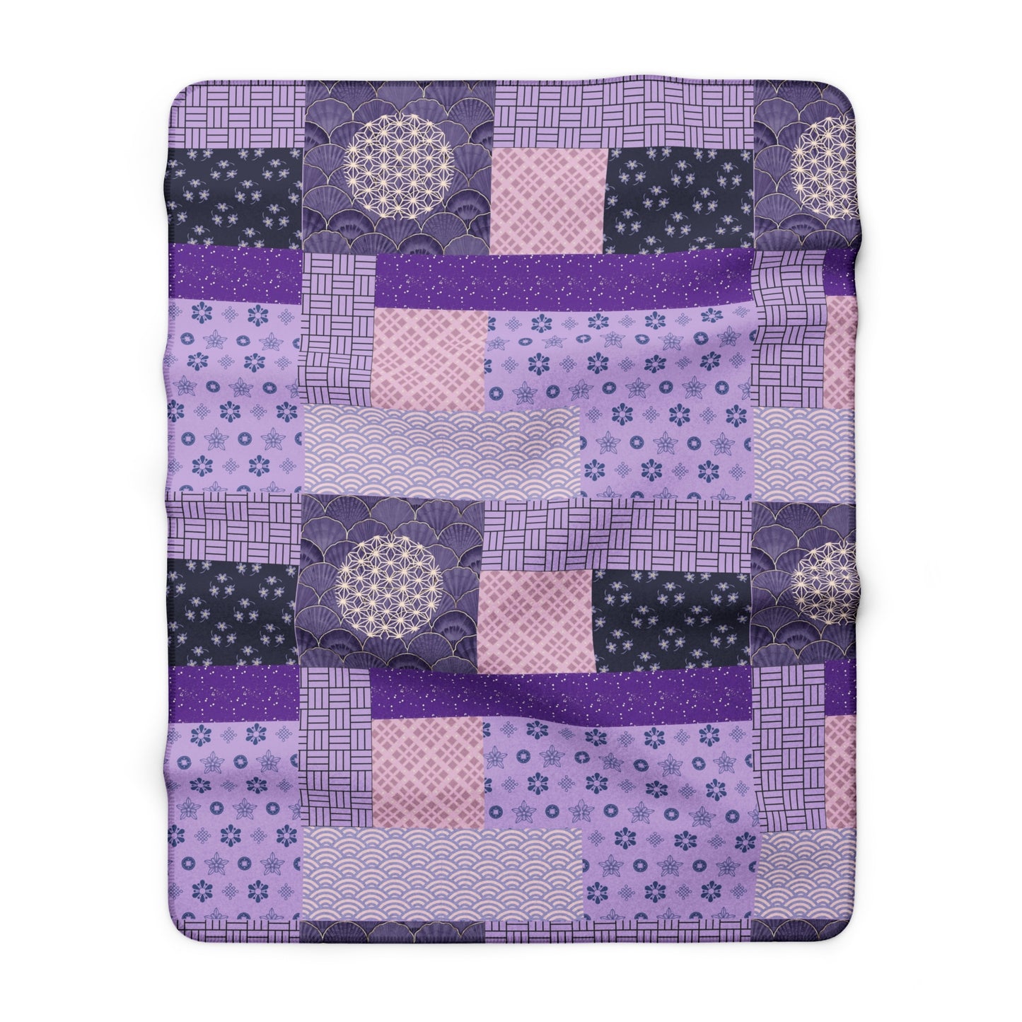 Patchwork quilt with purple and pink patterns on a white background