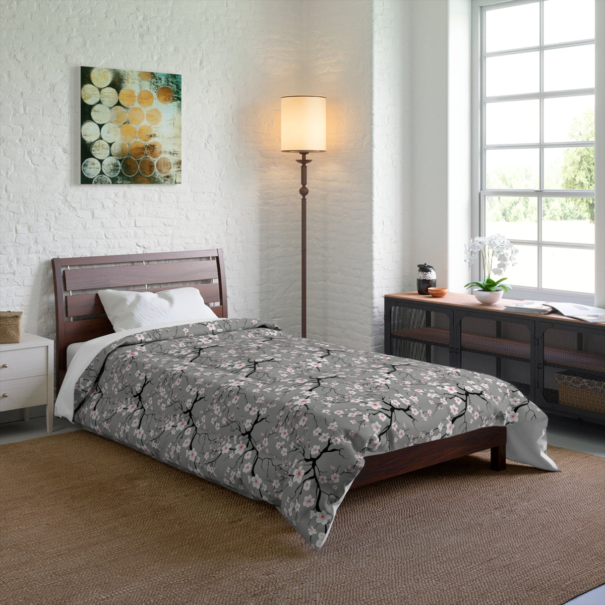 Bedroom with floral comforter on bed, lamp, and window.