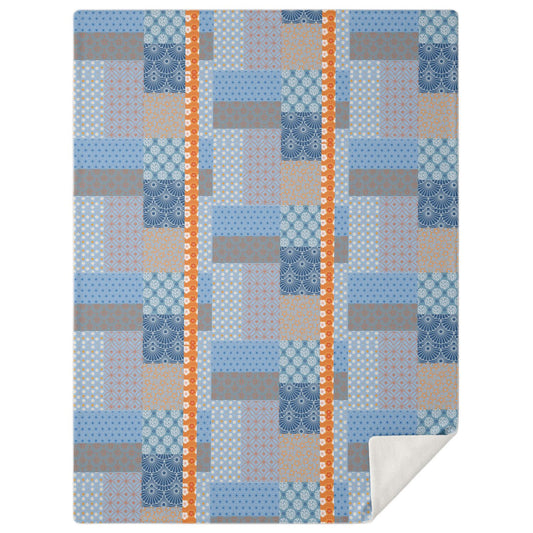 A high-angle, square photograph of a minimalist bedroom featuring a bed made of dark walnut wood. Spread neatly is the Kanazawa Seaside Dreams Patchwork Blanket from Kaito Japan Design. The blanket showcases a premium patchwork of indigo, slate blue, and charcoal tones with traditional Japanese Wagara motifs like Seigaiha waves and Asanoha hemp leaves. The room is uncluttered, with natural morning light casting soft, elegant shadows.