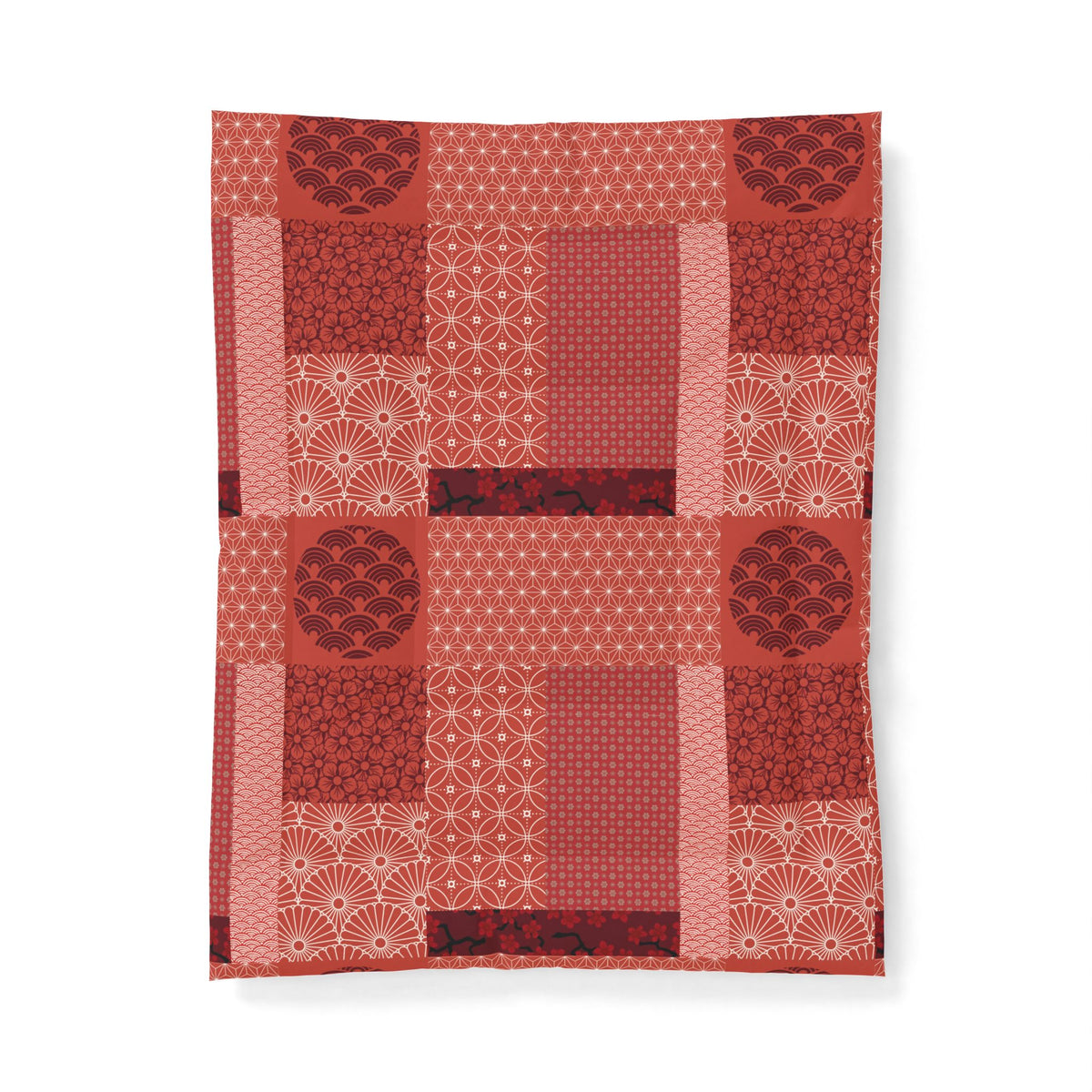 Red quilt with patterned blocks on a white background. Cotton Heritage