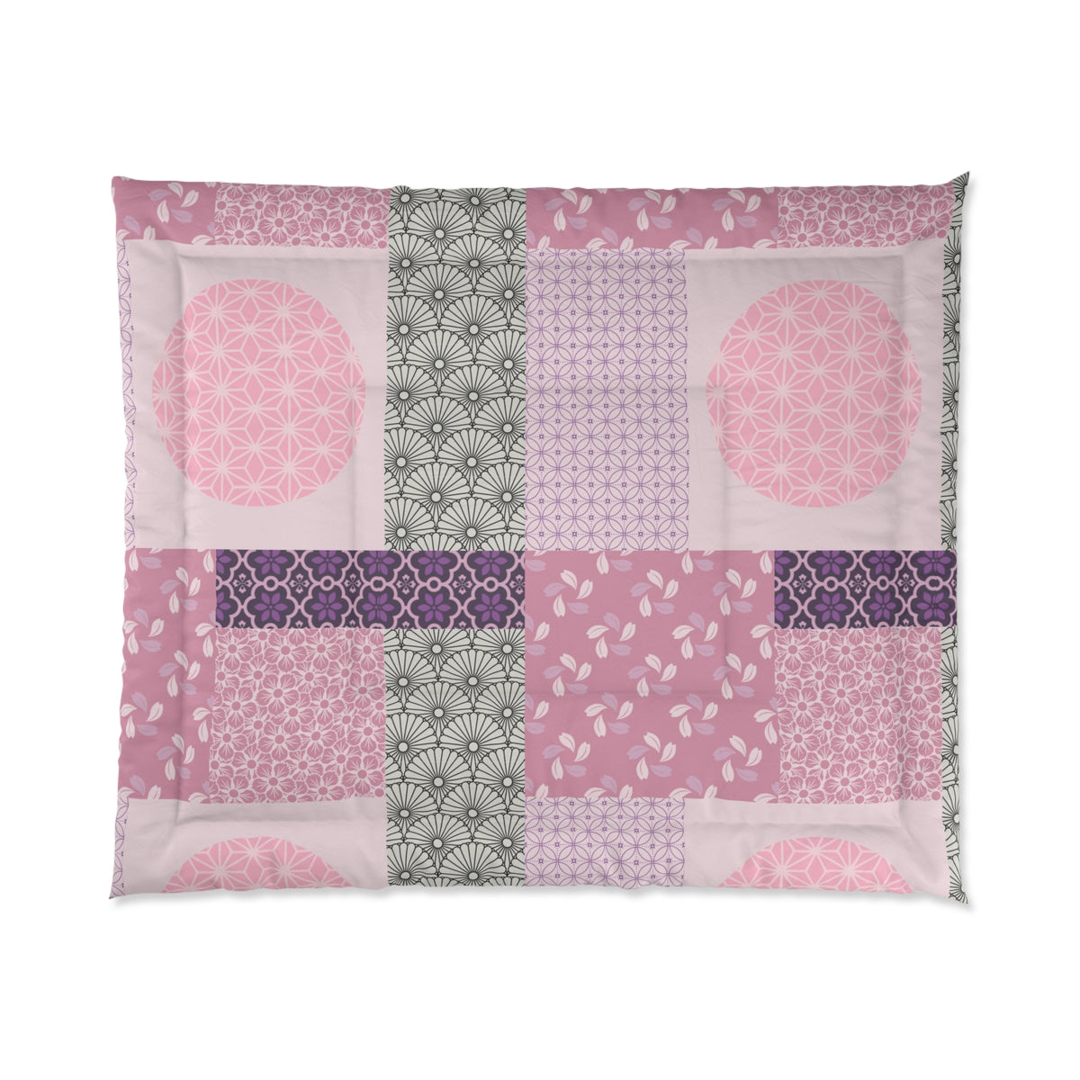 Patchwork quilt with pink, purple, and green patterns on a white background