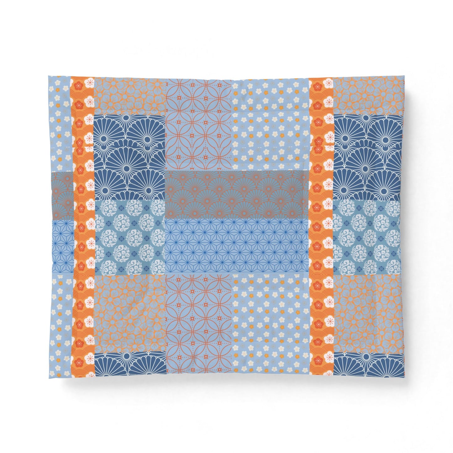 Patchwork pattern with blue, orange, and gray colors quilt on a white background. Heritage Cotton