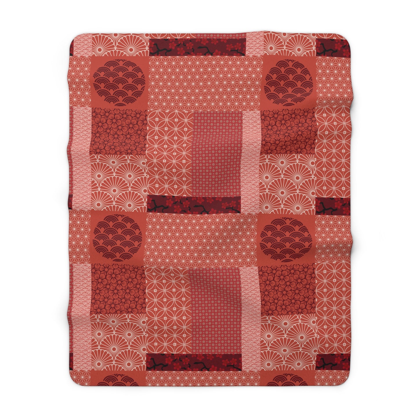 Red quilt with geometric pattern on a white background