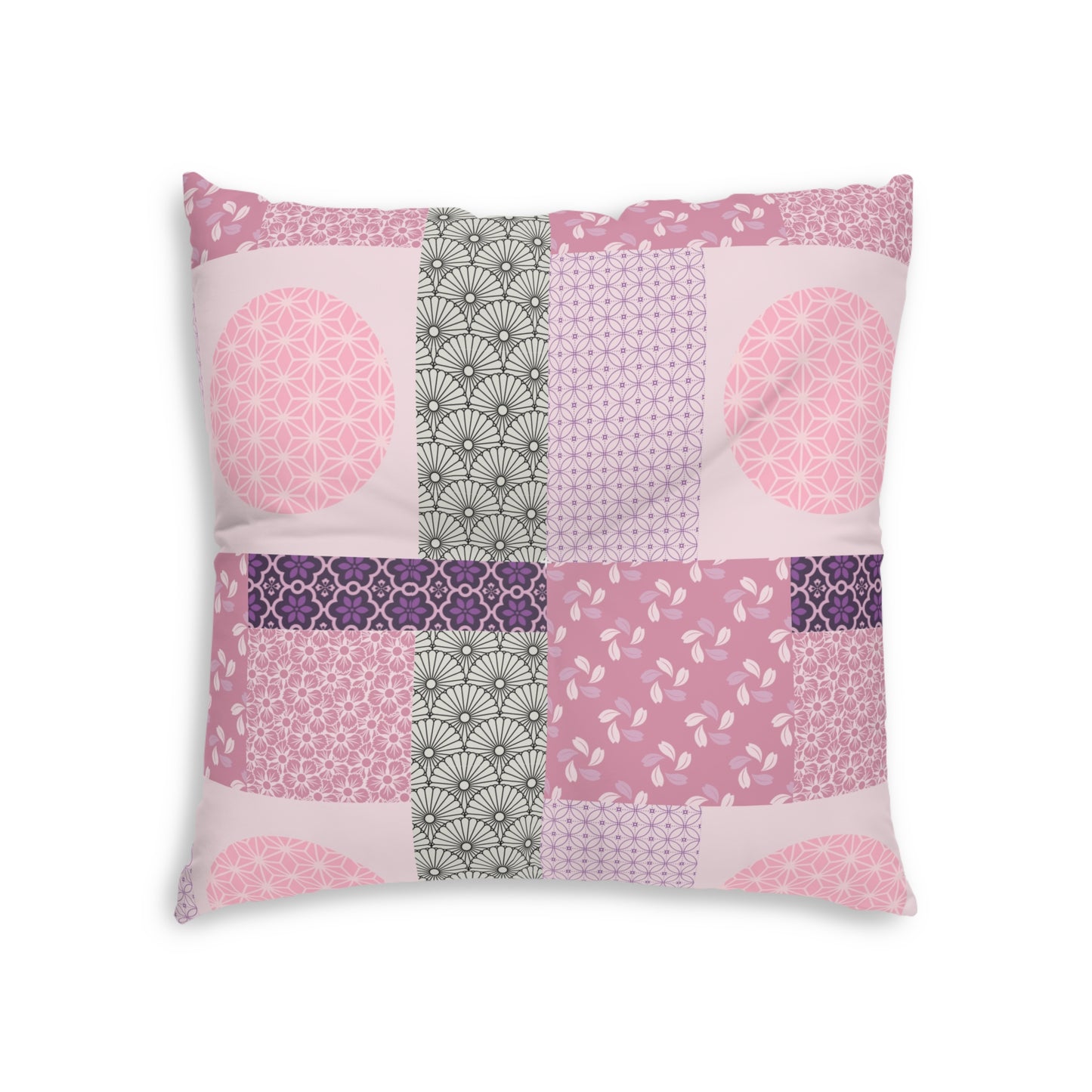 A square decorative throw pillow featuring a patchwork design of various pink, purple, and gray geometric and floral patterns on a white background.