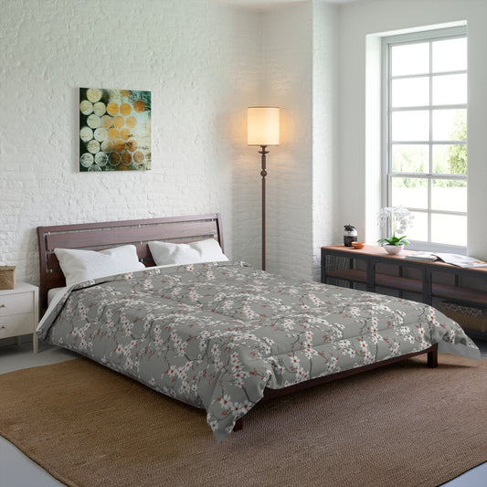 Bedroom with a bed featuring a gray comforter with orange floral patterns, a lamp, and a painting on the wall.