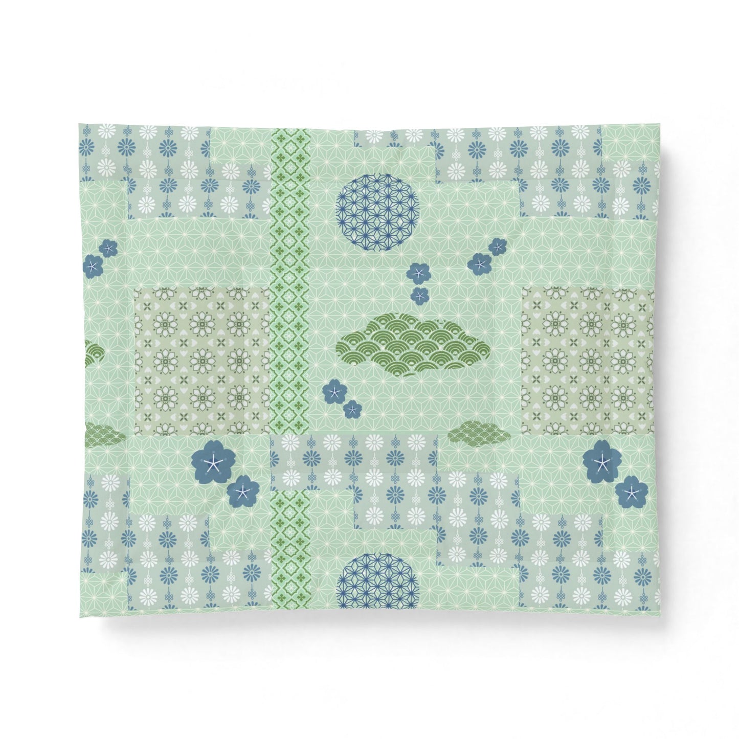 Patterned paper with green and blue designs on a light green background. Heritage Cotton