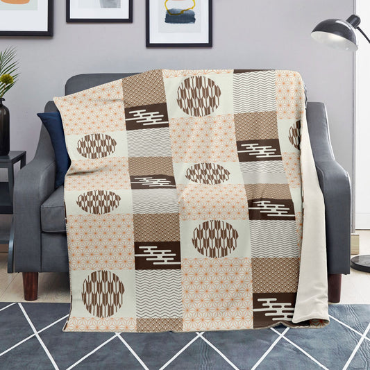 Patterned throw blanket draped over a chair in a living room setting.