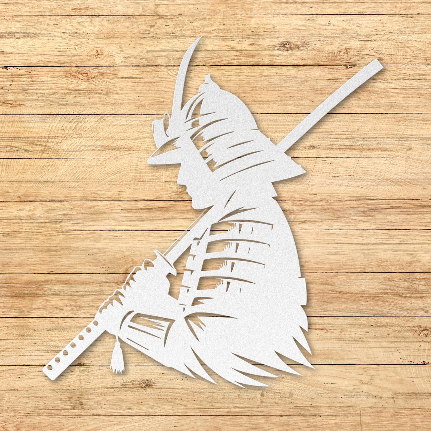 White metal sculpture of a warrior on a wooden surface