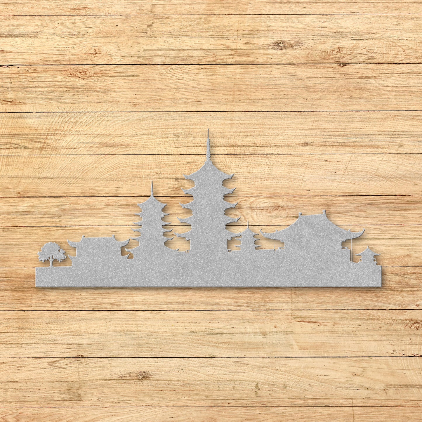 Silver Metal wall art of a city skyline on a wooden surface