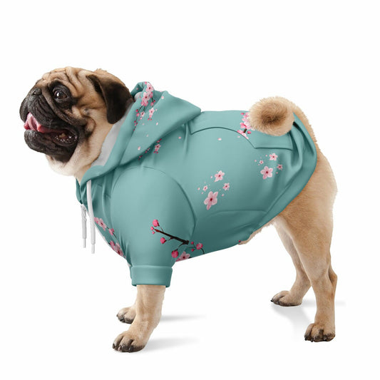 A dog wearing a premium sky-blue athletic zip-up hoodie featuring an intricate white and soft-blue cherry blossom pattern, inspired by Japanese spring landscapes