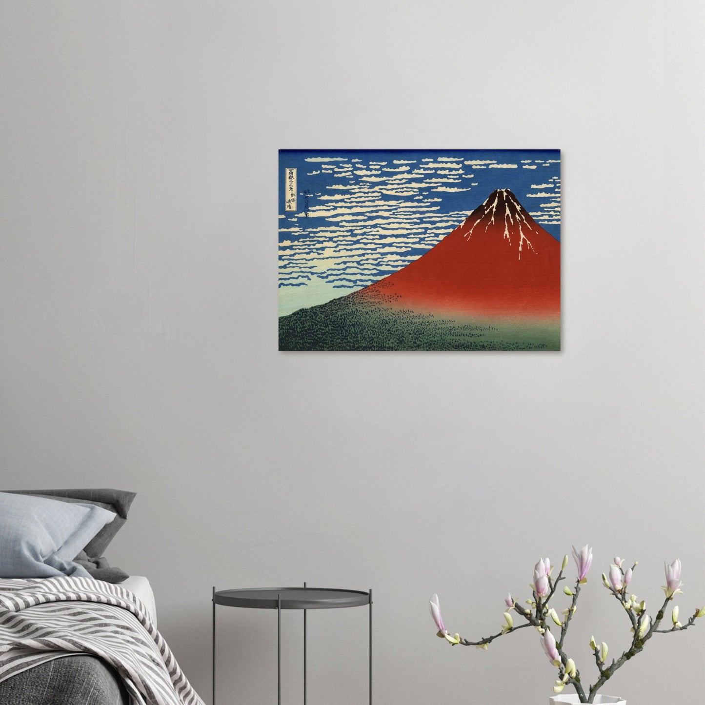 Canvas print of a mountain painting on a wall above a bed
