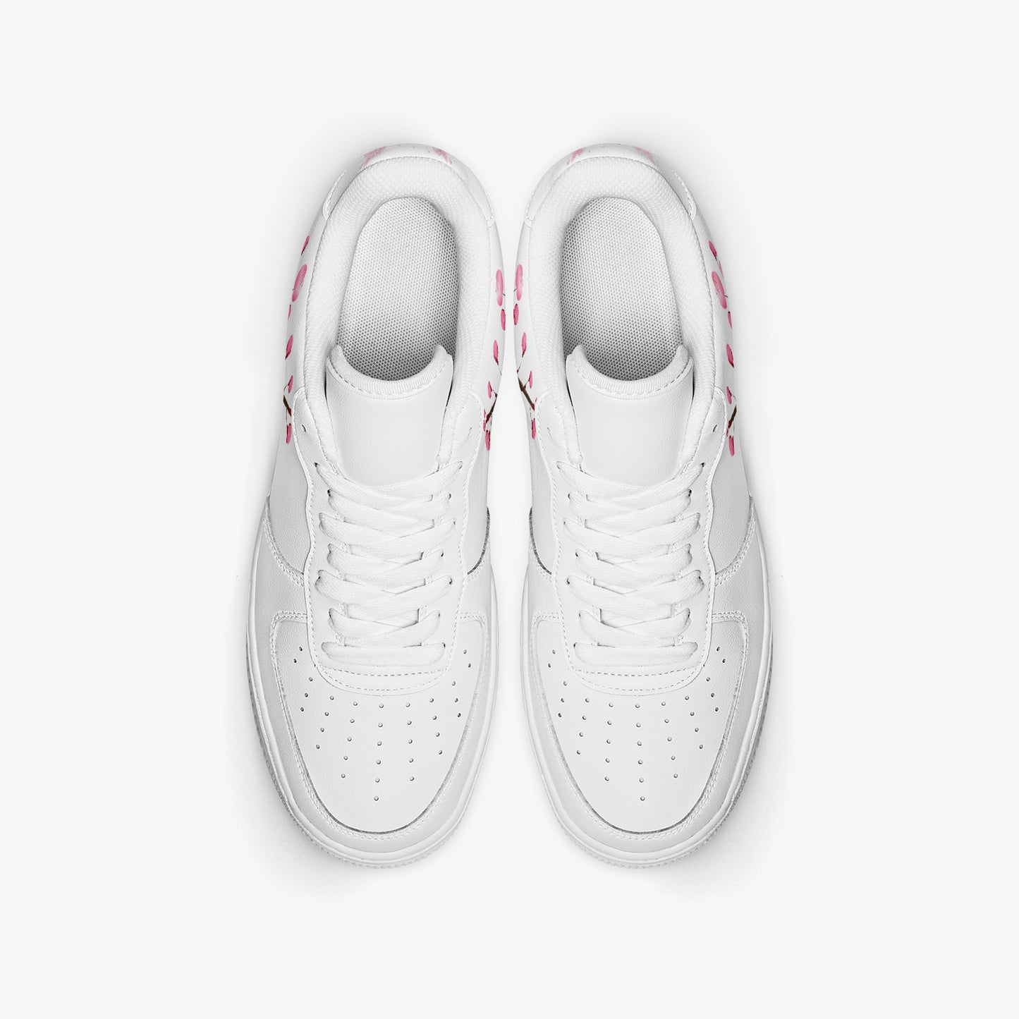 Pair of white sneakers with pink accents on a light gray background