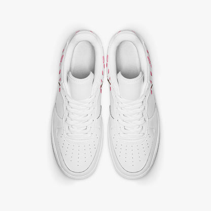 Pair of white sneakers with pink accents on a light gray background