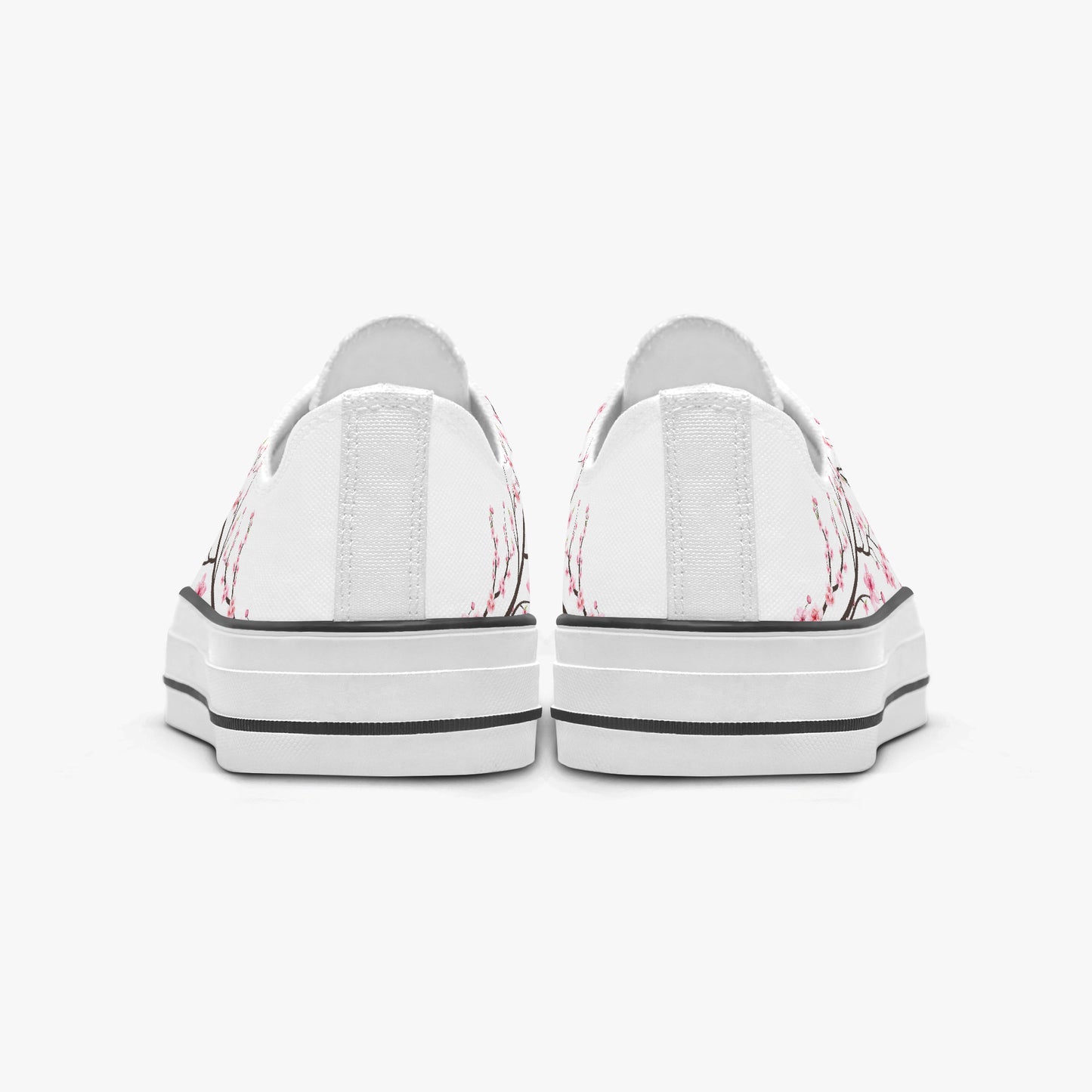 White sneakers with pink floral patterns on a white background