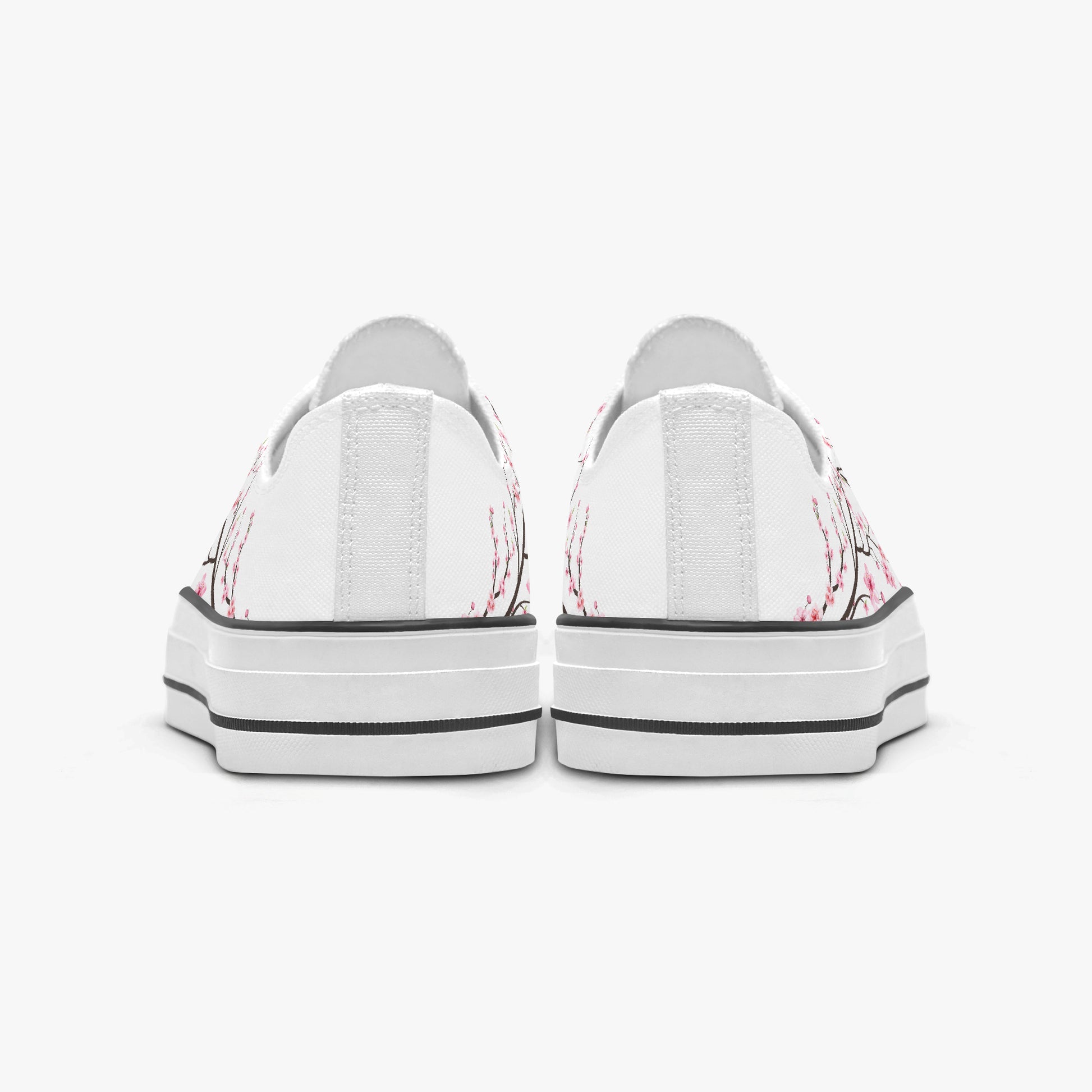White sneakers with pink floral patterns on a white background