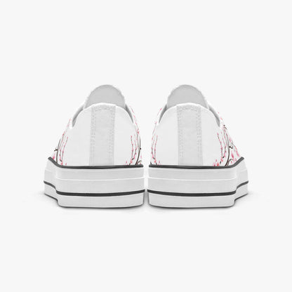 White sneakers with pink floral patterns on a white background