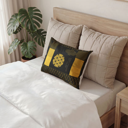 A decorative rectangular throw pillow with a black and yellow geometric pattern styled on a bed with beige pillows and white bedding, next to a potted green plant.