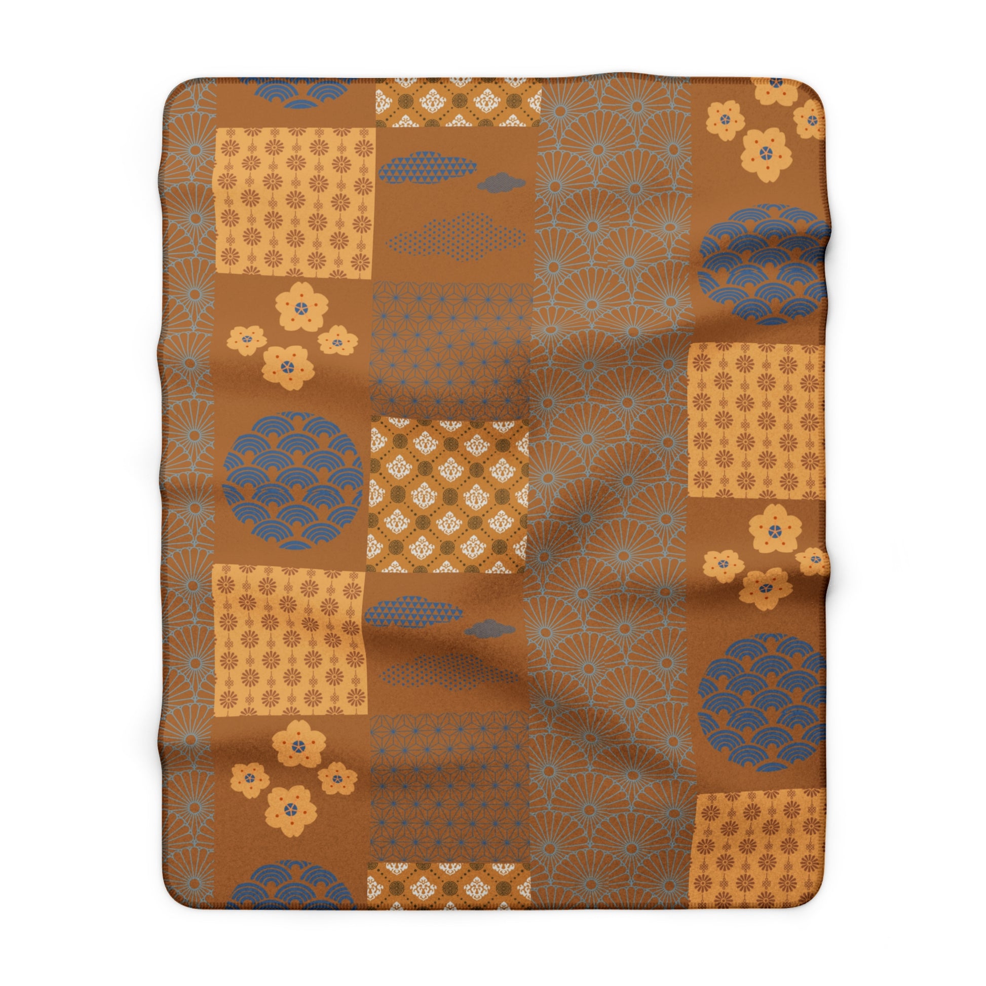 Patchwork blanket with brown and blue patterns on a white background