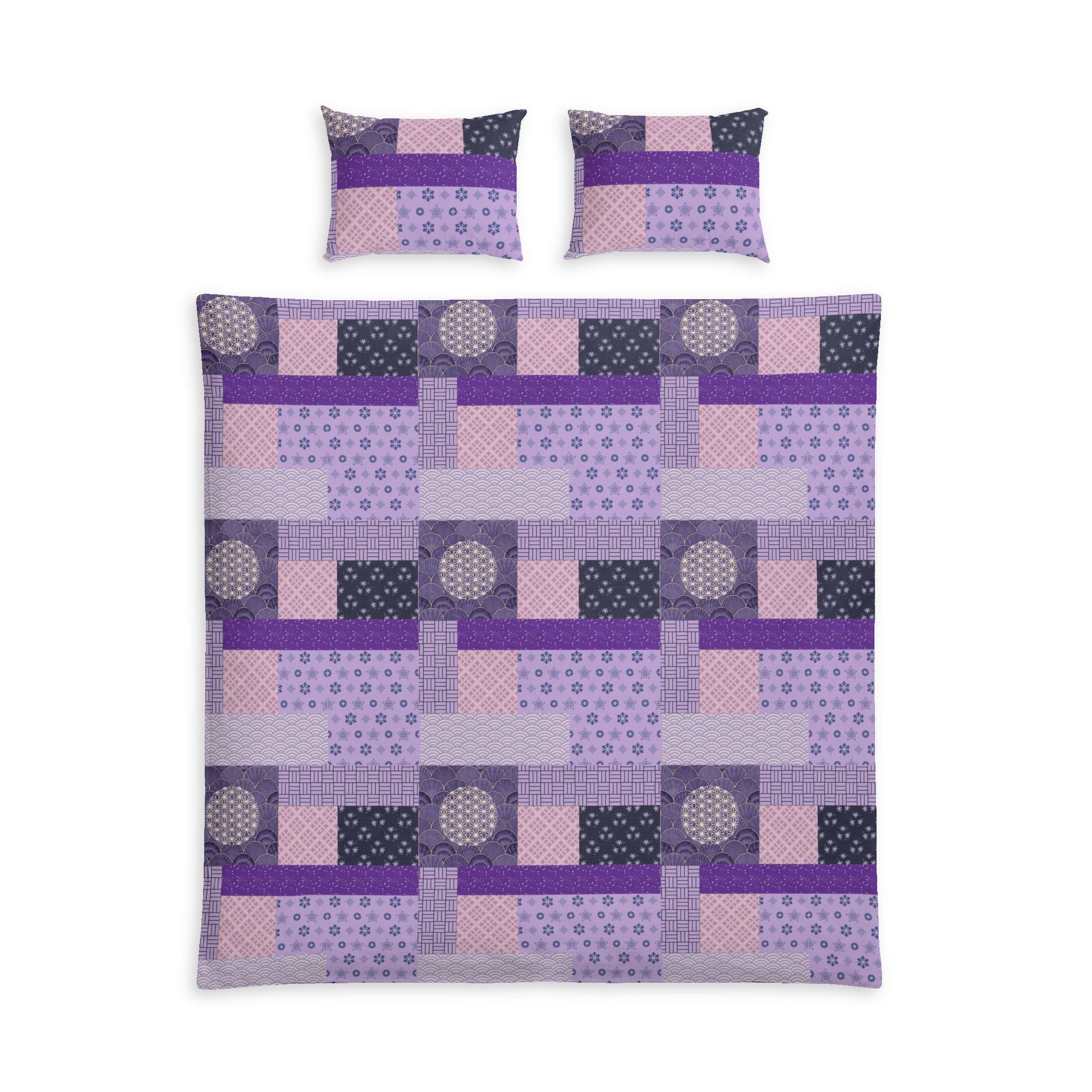 A bedding set featuring a patchwork quilt and two matching pillowcases in shades of purple, pink, and dark gray, displayed on a solid white background.