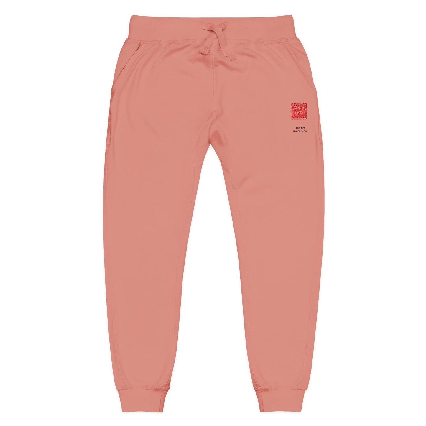 Coral sweatpants with a graphic design on a white background