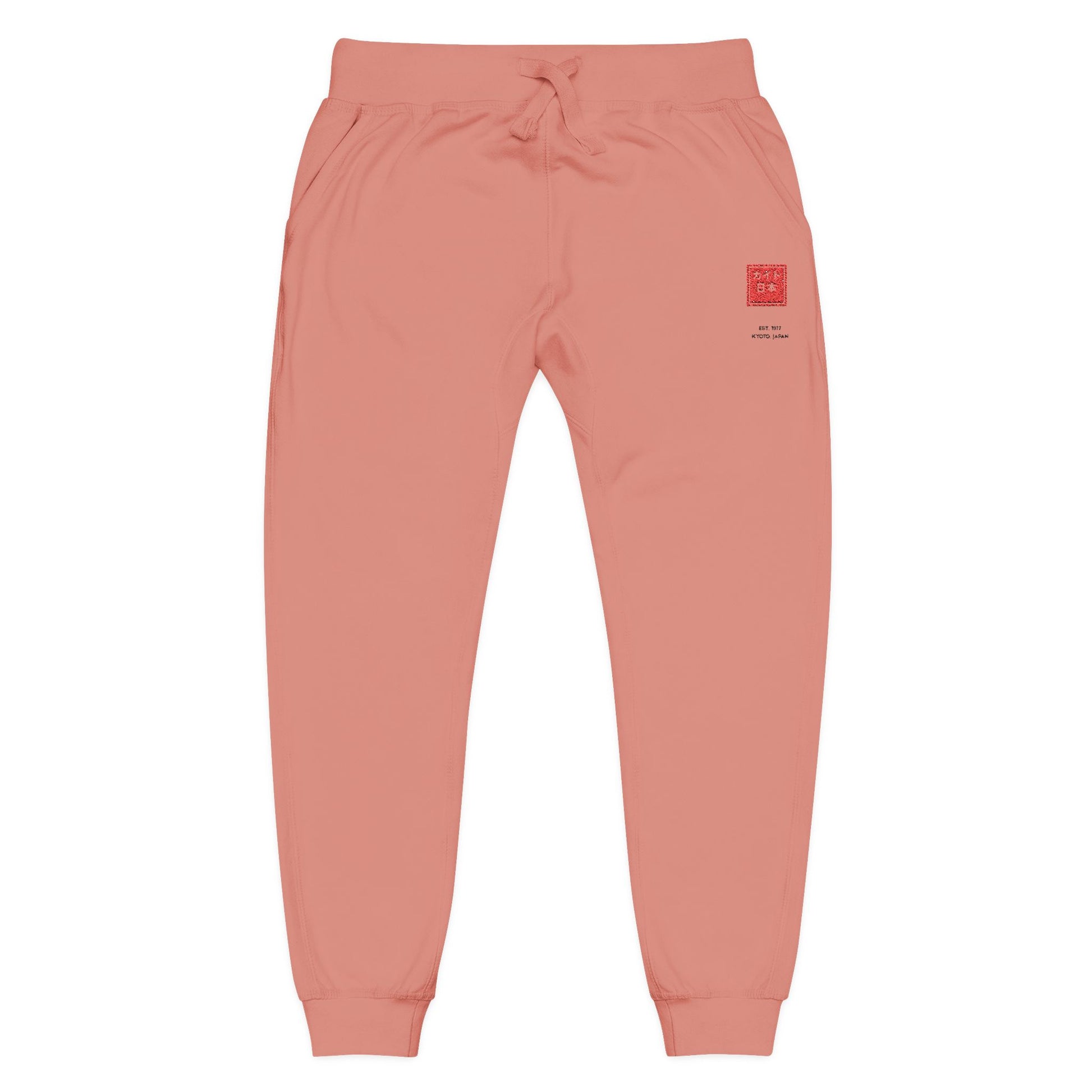 Coral sweatpants with a graphic design on a white background