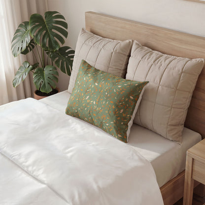 Neatly made bed with decorative pillows and a plant in the background