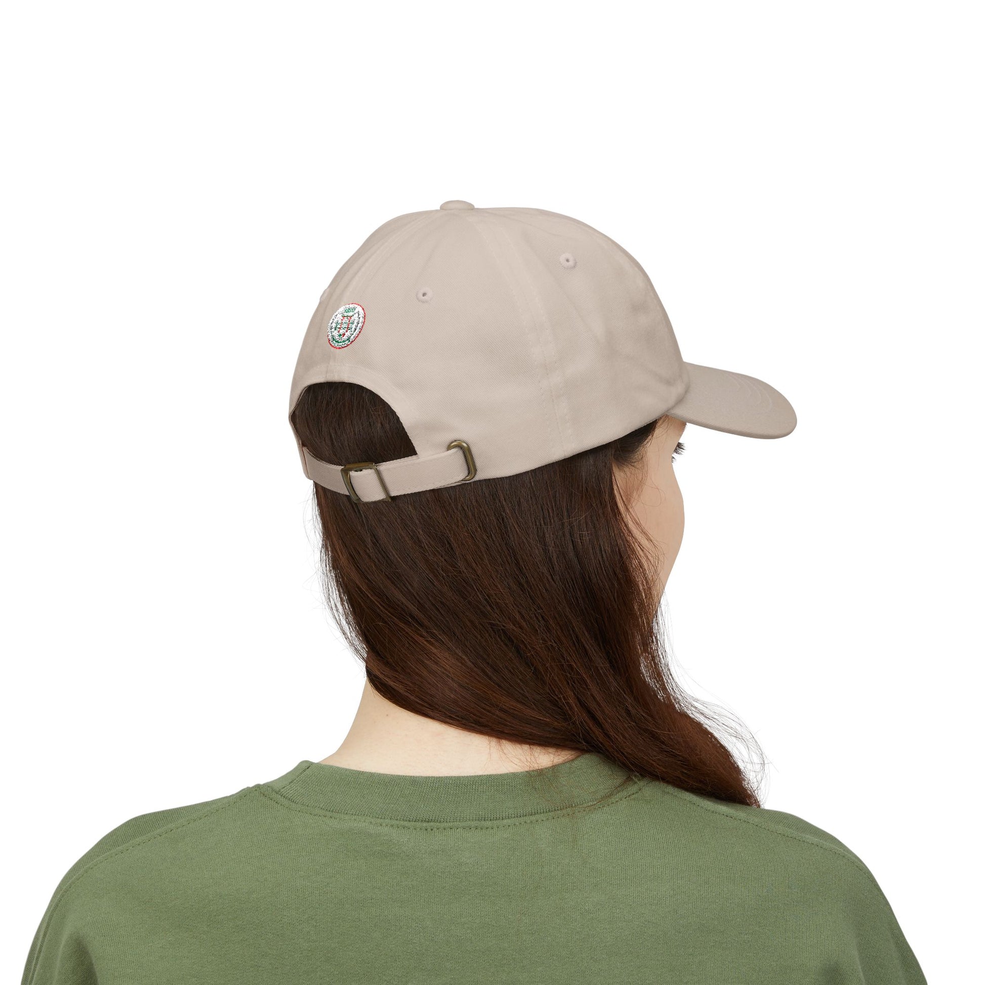 Person wearing a beige cap and green shirt on a white background