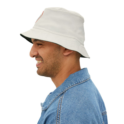 Man wearing a beige bucket hat and blue denim shirt on a white background