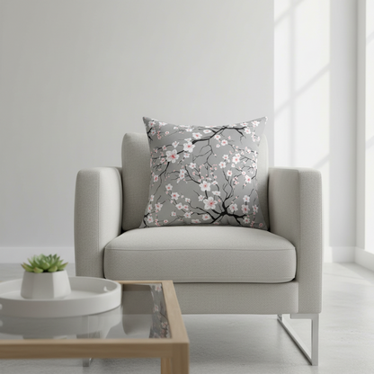 Gray armchair with a floral-patterned pillow in a bright room.