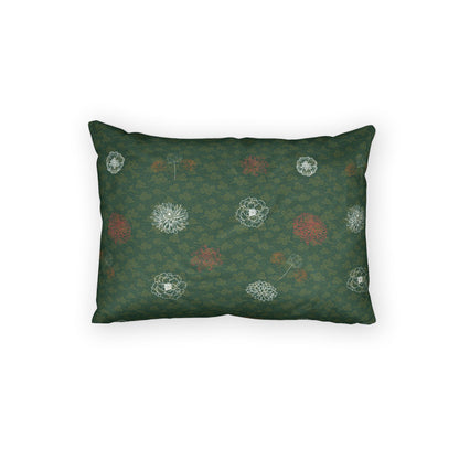 A rectangular throw pillow with a dark green damask pattern and scattered white and muted red floral motifs, shown against a plain white background.