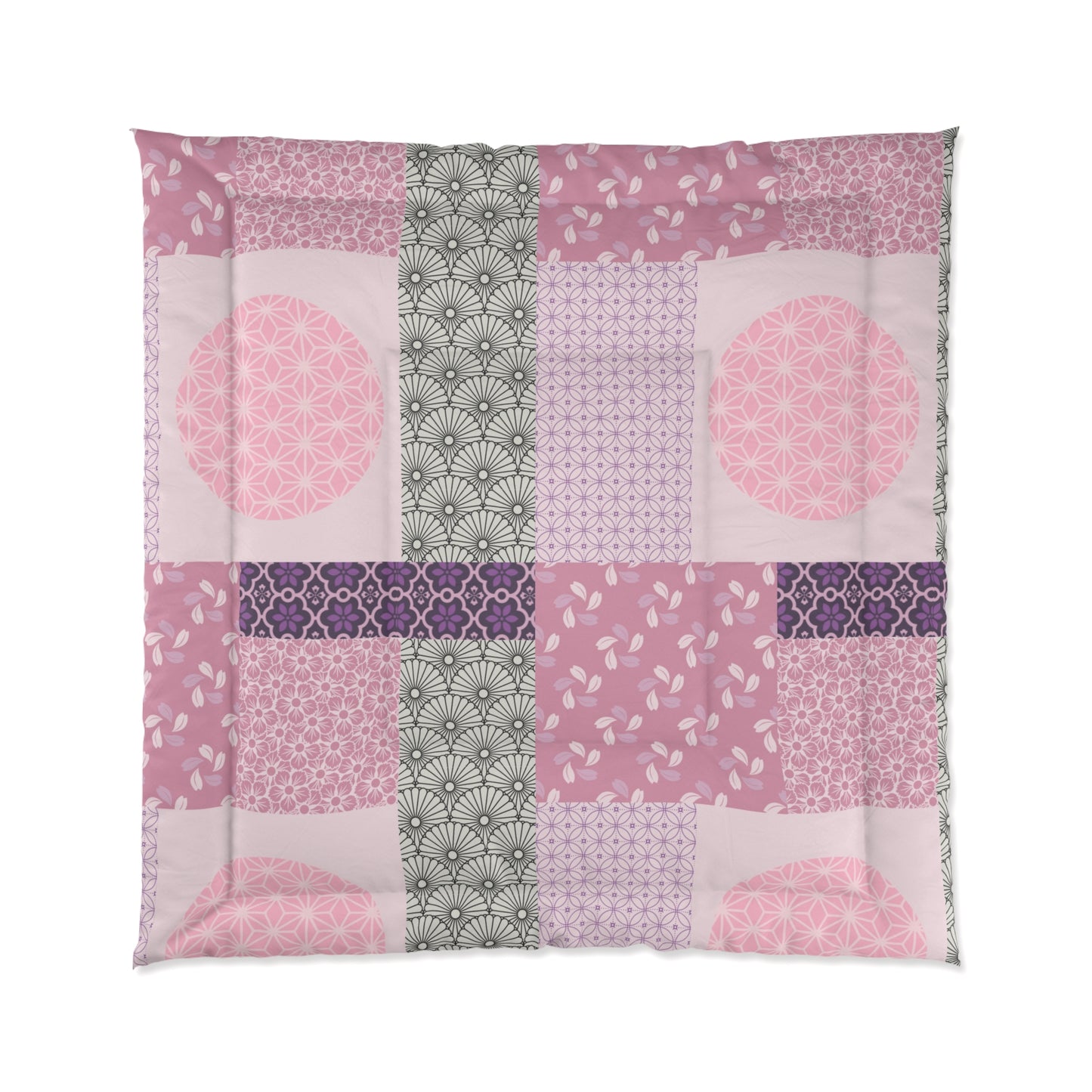Patchwork quilt with pink, purple, and green patterns on a white background