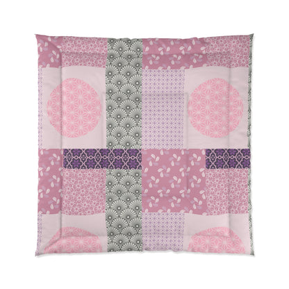 Patchwork quilt with pink, purple, and green patterns on a white background