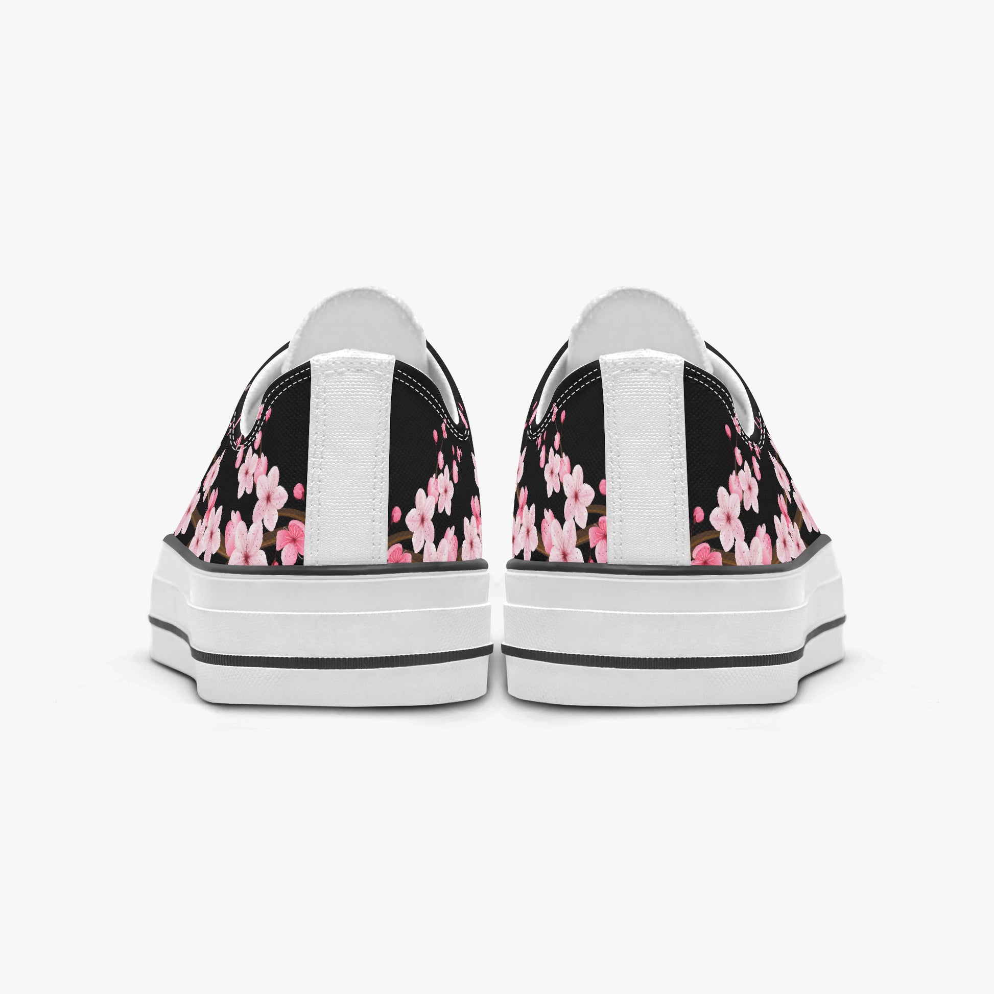 Black sneakers with pink floral pattern on a white background