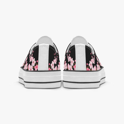 Black sneakers with pink floral pattern on a white background