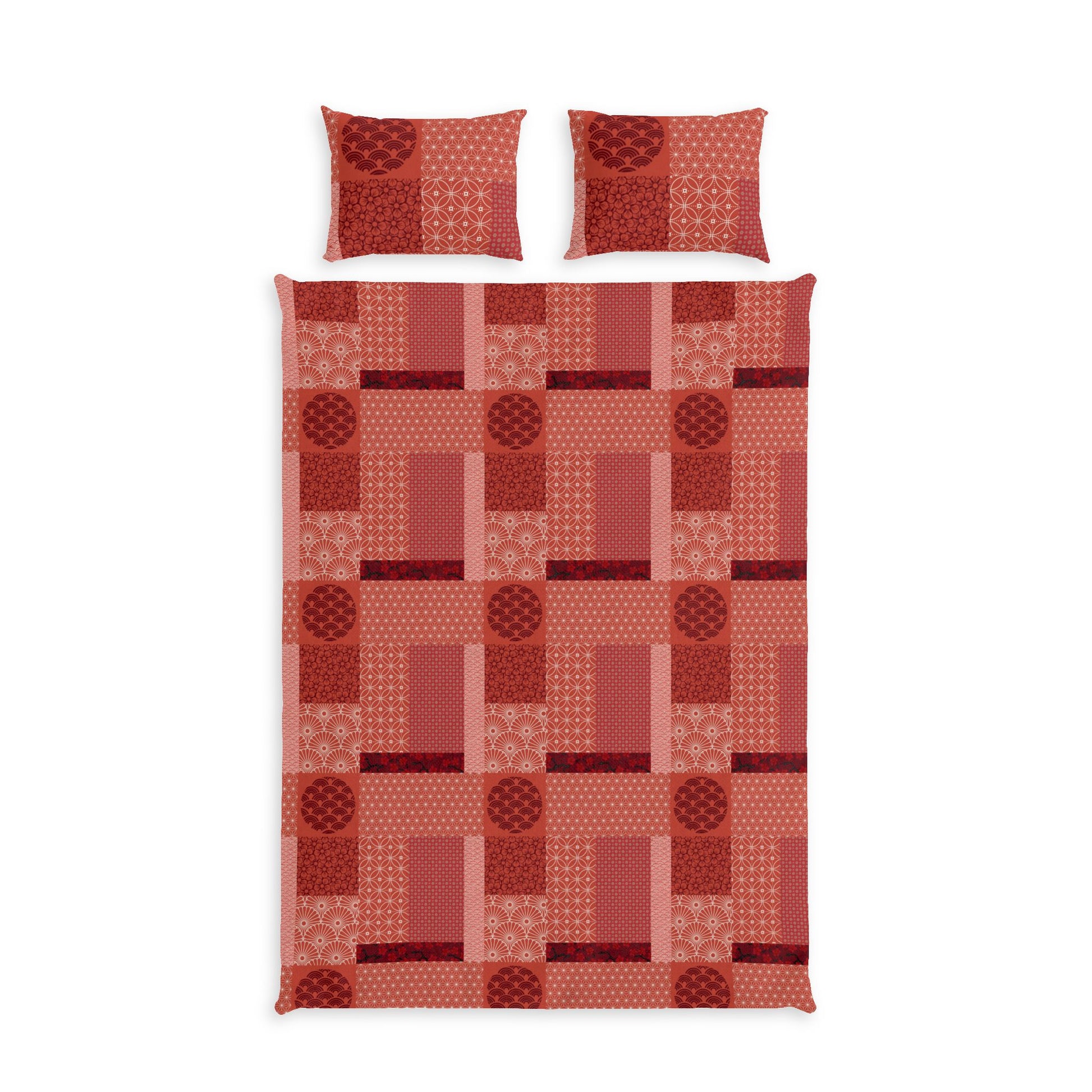 A bedding set featuring a patchwork quilt and two matching pillowcases in a warm red and orange geometric pattern, shown against a plain white background.