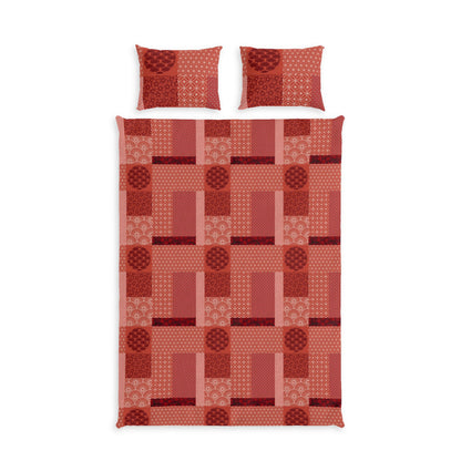 A bedding set featuring a patchwork quilt and two matching pillowcases in a warm red and orange geometric pattern, shown against a plain white background.