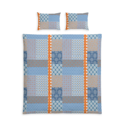 A bedding set featuring a patchwork quilt and two matching pillowcases with a blue, gray, beige, and orange geometric pattern on a white background.