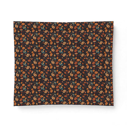 A rectangular fabric item, likely a blanket or pillow cover, featuring an all-over dense floral pattern in orange, brown, and teal on a dark charcoal background, shown against a plain white background.