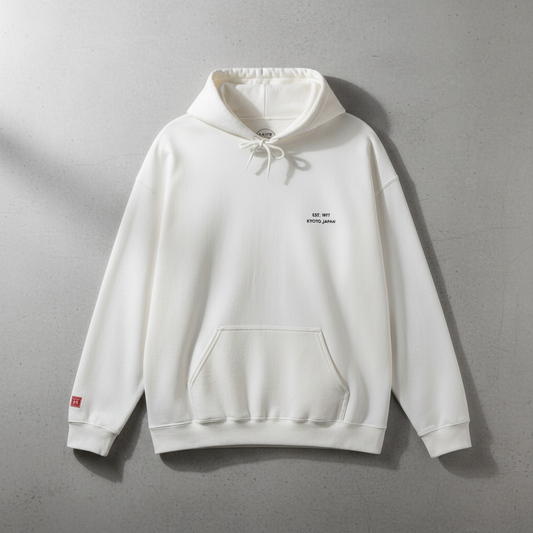 White hoodie with a small logo on a gray background