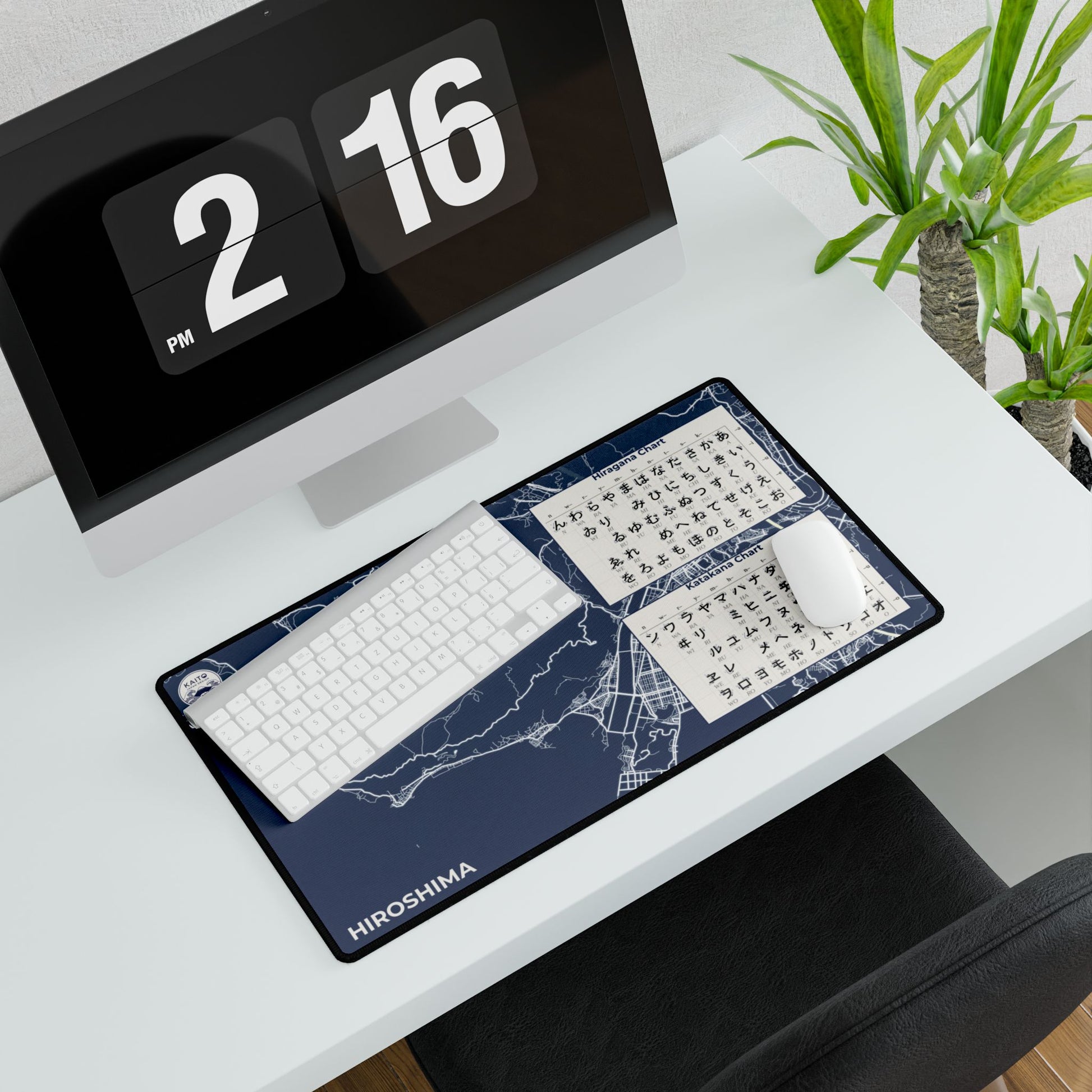 Desk setup with a keyboard and mouse on a desk mat, featuring a digital clock and plant in the background.